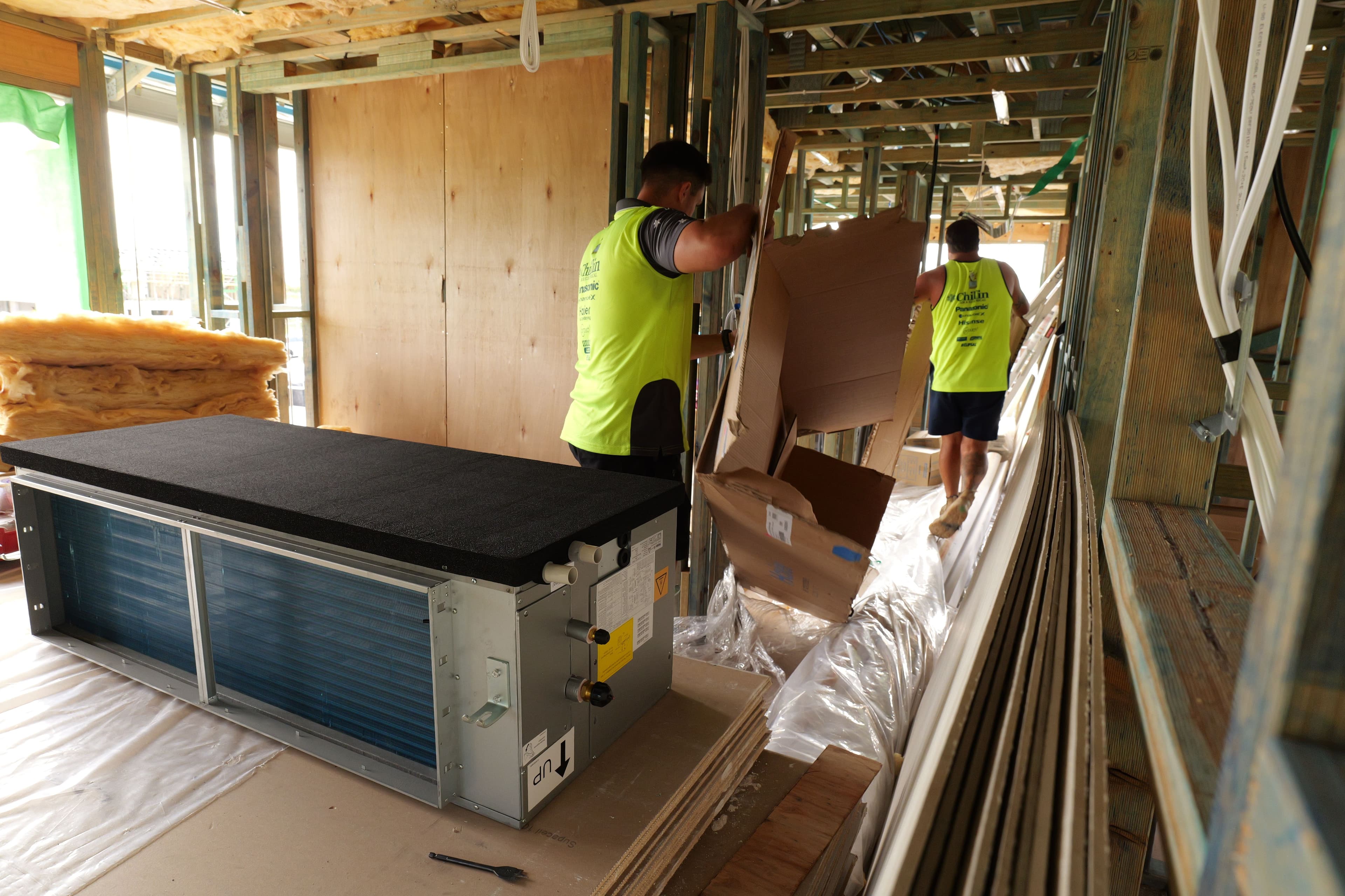 Chillin team positioning an indoor ducted air conditioning unit