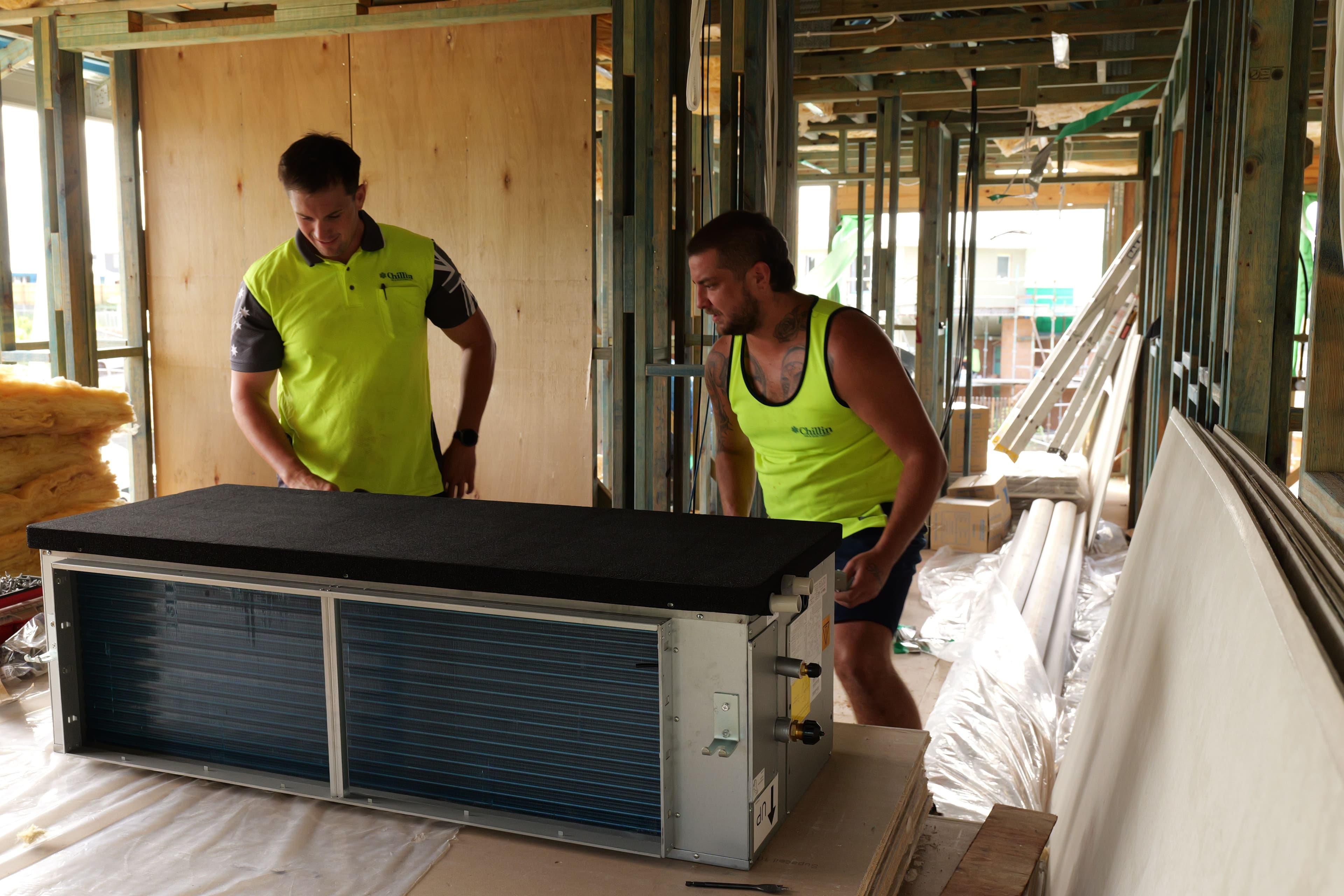 Chillin technicians installing ducted air conditioning equipment